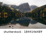 Alpine lake of Piburger See in the Otztal valley in the Austrian Tyrol during autumn, colorful trees in the Alps