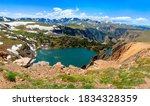 Alpine lake and snowy mountain in high altitude near Yellowstone National Park in Wyoming, off of Beartooth Highway between Red Lodge and Yellowstone National Park.