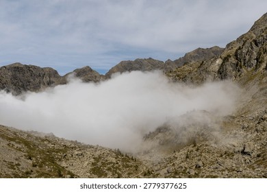 Alpine landscape with dramatic clouds in the Belledonne Massif, French Alps, Isère