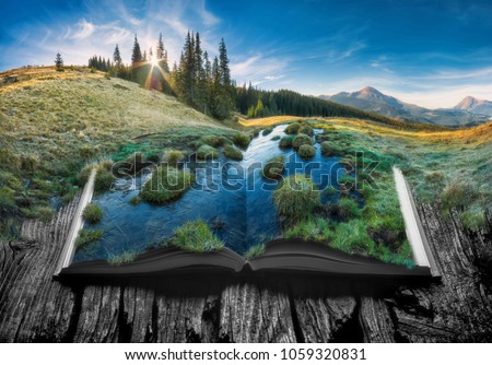 Alpine mountain valley in a light of sunrise on the pages of an open magical book. Majestic landscape. Nature concept.