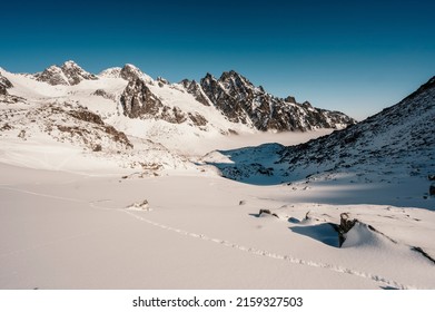 Alpine mountains landscape with white snow and blue sky. Frosty trees under warm sunlight. Wonderful winter landscape. Adventure winter sport. High tatras, slovakia landscape
