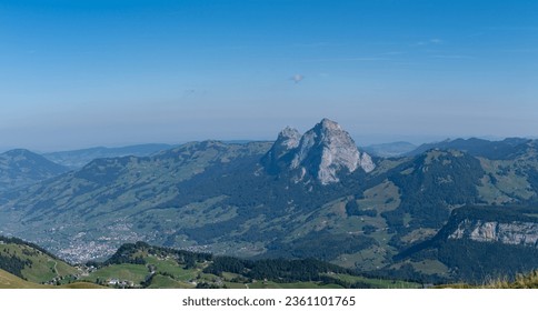 Alpine panoramic view from Fronalpstock in the Swiss mountains, overlooking the peaks of the grosser und kleiner Mythen on a sunny autumn day