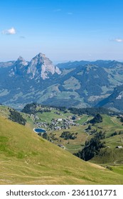 Alpine panoramic view from Fronalpstock in the Swiss mountains, overlooking the peaks of the grosser und kleiner Mythen on a sunny autumn day
