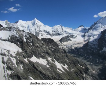 Alpine peaks above a glacier moraine valley - with a highlight on Ober Gabelhorn - on a Summer day in the Pennine Alps in Val d'Anniviers - Switzerland