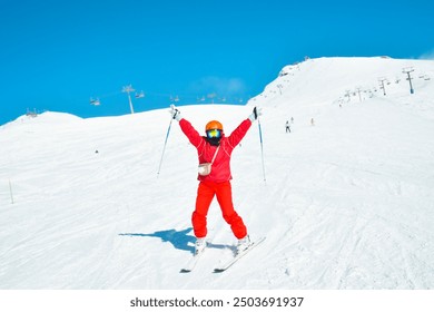 Alpine ski. Skiing woman skier going downhill on snow covered isolated white ski trail slope piste in winter. Good recreational female skier in white ski jacket and red outfit - Powered by Shutterstock