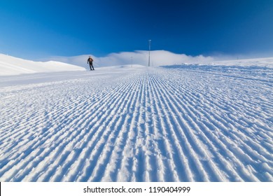 alpine skier on a fresh ski slope - Shutterstock ID 1190404999
