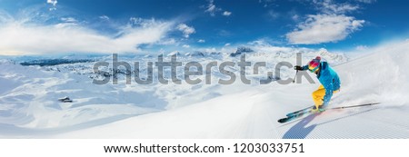 Alpine skier skiing downhill, panoramic format. Winter sports and leasure activities