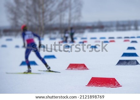 Alpine skiing race slalom competition, athletes ready to start ski competitions on a piste slope, nordic ski skier on the track in winter, giant slalom, winter sport and acitivities concept 