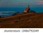 Alpine sunset or sundowner with Steinlingalm chapel at Mount Kampenwand, Aschau, Chiemgau, Rosenheim, Bavaria, Germany