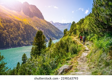 Alpine Track And Two Hikers At Mountain Lake