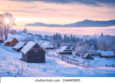 Alpine ukrainian village on a hill with mountain ridge on horizon. Frozen winter morning in carpathian mountains, Europe travel, beauty world, Happy New Year, Marry Christmas. - Powered by Shutterstock