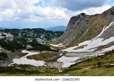 Alpine Valley Above Pokljuka In Julian Alps And Triglav National Park, Slovenia With Melting Snow In Spring