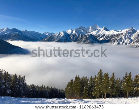 Alpine View With Clouds Below The Ski Snowboarding Hill In Canadian Rockies Panorama Alpine View With Clouds Below The Ski Snowboarding Hill In Canadian Rockies Panorama