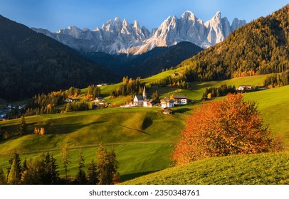Alpine village in the autumn mountain valley. Autumn mountain village. Mountain village in autumn landscape. Autumn in mountain valley
