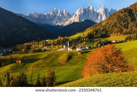 Alpine village in the autumn mountain valley. Autumn mountain village. Mountain village in autumn landscape. Autumn in mountain valley