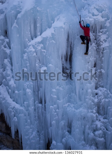 Alpinist\
ascenting a frozen waterfall in Ice park,\
Ouray.