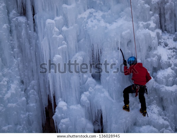 Alpinist\
ascenting a frozen waterfall in Ice park,\
Ouray.