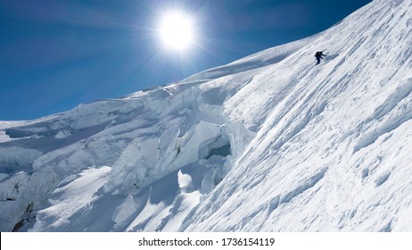 An alpinist climbing up the seracs of the Mont Blanc north face. Last meters before the summit.