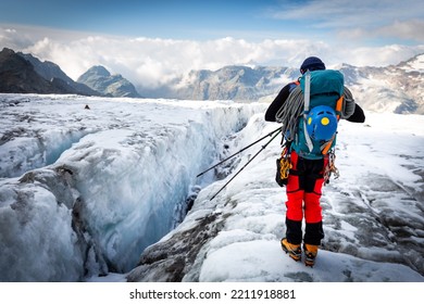 Alpinist Mountaineer Back View Standing Above Crevasse, High Mountains Peaks Ridge Range View, Italian Alps  Mountaineering Tourism, Travel Explore Europe Nature.