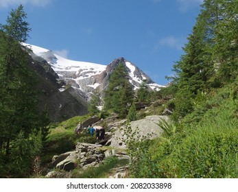 Alps, Switzerland - circa July 2016:  View with resting tourists on mountain path on the route from the Col de la  Forclaz pass to the Col de Balme. Tour du Mont Blanc