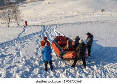 Altai Republic, Siberia, Russia - 3d January, 2021: Tourism In The Region. Tourists Do Snow Rafting At Sunny Day.