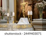 The altar of the lutheran church before the service. Altar candles, Bible, crucifix, flowers. The moment before Eucharistic.