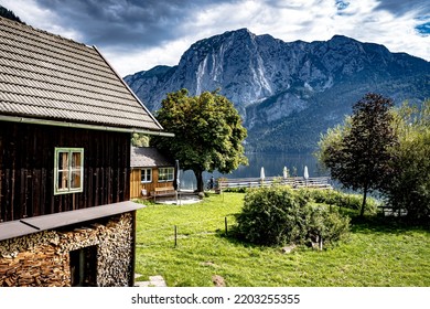 Altaussee, Austria - Sept 7th 2022: View Of A Typical Historical Lake House With Firewood For The Winter In Front Of The Cottage On The Water In Altaussee, Ausseer Land, Styria, Austria