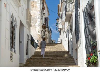 Altea, Spain - 6 May 2022: A Lady Climbing Altea Old Town Steps In Alicante On The Costa Blanca Coast In Spain