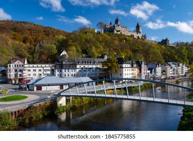 Altena Castle “Burg Altena“ in Sauerland Germany is a famous Landmark monument and Mediaval Sight with First Youth Hostel of the World on a sunny colorful autumn day with new bridge over river Lenne
