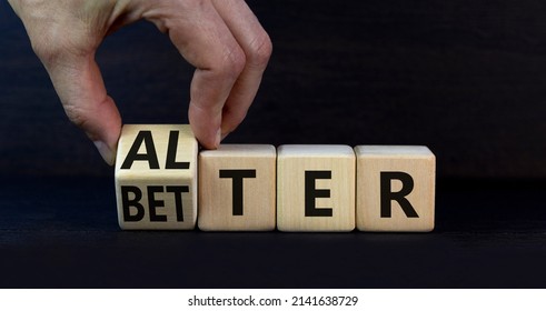 Alter or better symbol. Businessman turns wooden cubes and changes the word Alter to Better. Beautiful grey table, grey background, copy space. Business and alter or better concept.
