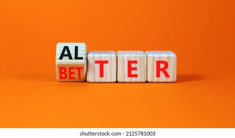 Alter or better symbol. Turned wooden cubes and changed the word Alter to Better. Beautiful orange table, orange background, copy space. Business and alter or better concept.