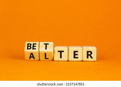 Alter or better symbol. Turned wooden cubes and changed the word 'alter' to 'better'. Beautiful orange background, copy space. Business and alter or better concept.