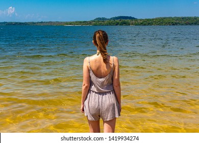 ALTER DO CHAO, BRAZIL - CIRCA SEPTEMBER, 2018: Woman walks in the waters of the Tapajós River that bathe the beaches of the Ilha do Amor, in Alter do Chão, state of Pará