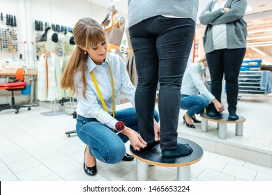 Alterations Tailor Measuring Trousers On A Customer, Close-up