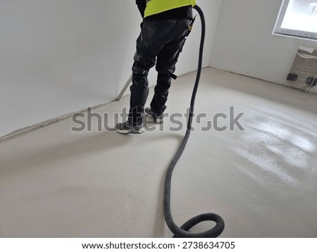 Alternative angle of professional post-construction cleaning with an industrial vacuum cleaner in a renovated room.