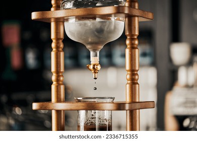 alternative brewing of espresso, cold drip coffee maker, cold water dripping on fresh ground coffee - Shutterstock ID 2336715355
