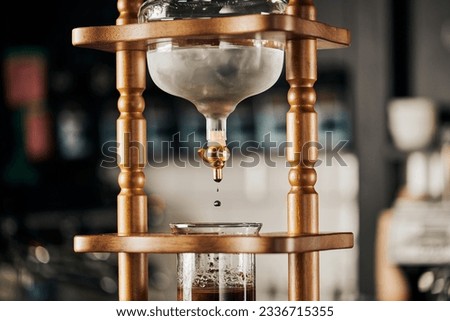 alternative brewing of espresso, cold drip coffee maker, cold water dripping on fresh ground coffee