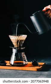 Alternative coffee brewing method, using pour over dripper and paper filter on black background.  - Shutterstock ID 2077063948