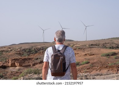 Alternative Energy, Wind Farm On The Mountain In Tenerife. Back View Of Mature Man Looking At  Wind Turbines Farm. Concept Of Renewable Energy, Love Of Nature, Clean, Green Electricity, Future.