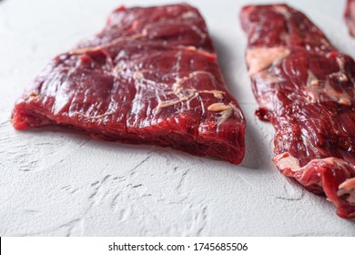 Alternative Flank Steak, Churrasco Beef Organic Meat Cut Side View Close Up Over White Concrete Background