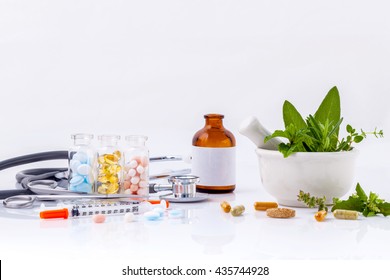 Alternative health care concept. Fresh herbs green mint ,rosemary ,parsley ,sage and lemon thyme in laboratory glassware with stethoscope on wooden background.