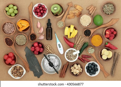 Alternative Medicine And Food Selection For Cold Remedy With Acupuncture Needles, Moxa Sticks And Thermometer Over Ridged Brown Paper Background. Immune Boosting.