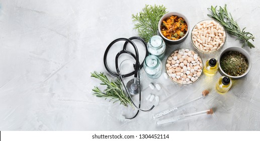 Alternative medicine herbs and homeopathic globules. Homeopathy medicine concept. Top view with copy space - Shutterstock ID 1304452114
