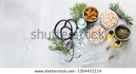 Alternative medicine herbs and homeopathic globules. Homeopathy medicine concept. Top view with copy space