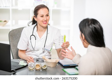 Alternative Medicine - Homeopathy.Young Woman In An Office At The Doctor Homeopaths.  Treatment With Herbs. 