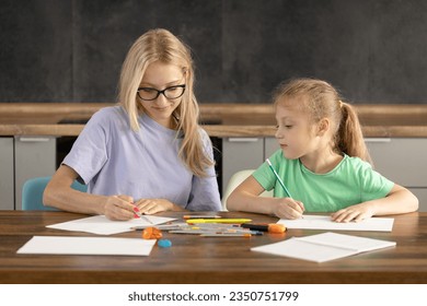 Alternative Pedagogy. A young woman teacher is engaged in individual lessons with a toddler girl. Online classes through a laptop, online lessons at distance home learning.  creative skills in a child