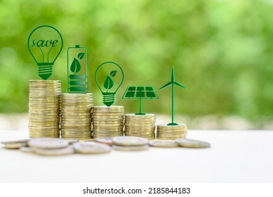 Alternative or renewable energy financing program, financial concept : Green eco-friendly or sustainable energy symbols atop five coin stacks e.g a light bulb, a rechargeable battery, solar cell panel - Shutterstock ID 2185844183