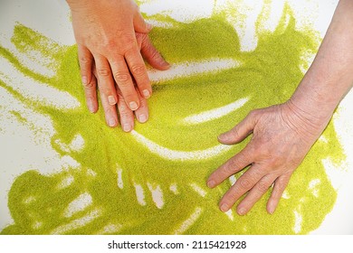 alternative sand therapy, hands of young and elderly women on kinetic sand, rehabilitation after a stroke. - Powered by Shutterstock