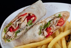 Alternative Taco Or Burrito Which Includes Traditional Sandwich Fillings Wrapped In A Tortilla. Cheesy Chicken Wrap In Tortilla Served On White Plate.