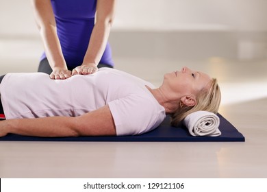 Alternative traditional medicine and massage, young spirit healer doing reiki treatment to old woman. Waist up, copy space - Powered by Shutterstock